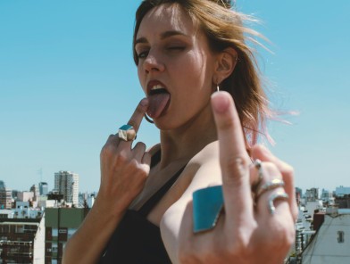 Escort showing middle finger as a bold message to restrictive payment services.