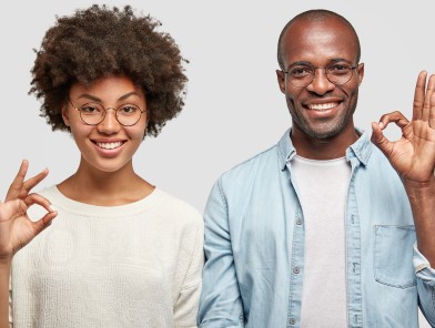 Two people showing OK hand gestures to each other, symbolizing mutual consent and agreement for sexual activity.